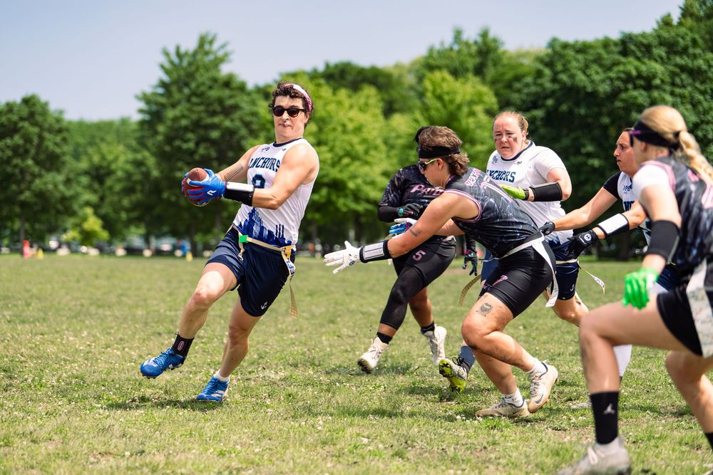 A flag football athlete dodges a pull attempt on the flags to stop the play at Pride Bowl hosted by NGFFL in Chicago