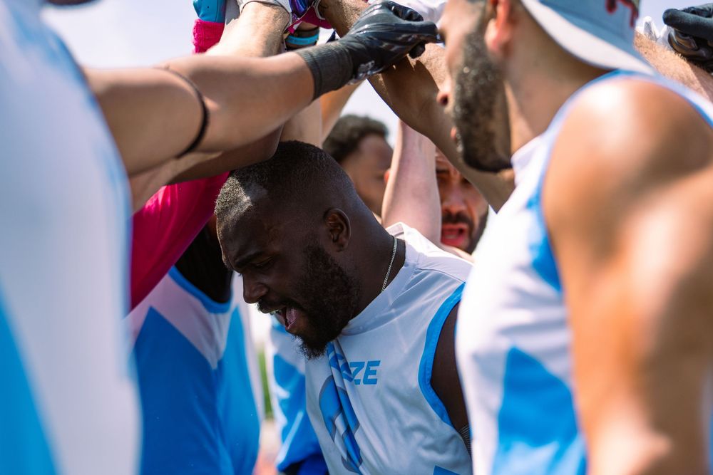 The captain of the Chicago Freeze leads a chant with his athletes in a huddle on the sideline at Pride Bowl hosted by NGFFL in Chicago