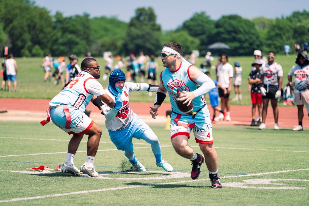 The Chicago quarterback attempts to create distance from a rusher from Michigan in a semi-final game at Pride Bowl hosted by NGFFL