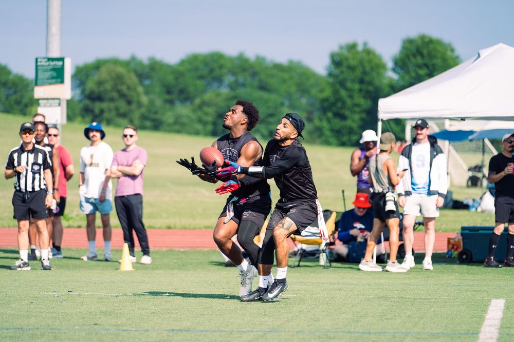 A flag football athlete attempts to breakup a pass arriving into the arms of the offensive opponent at Pride Bowl hosted by NGFFL in Chicago