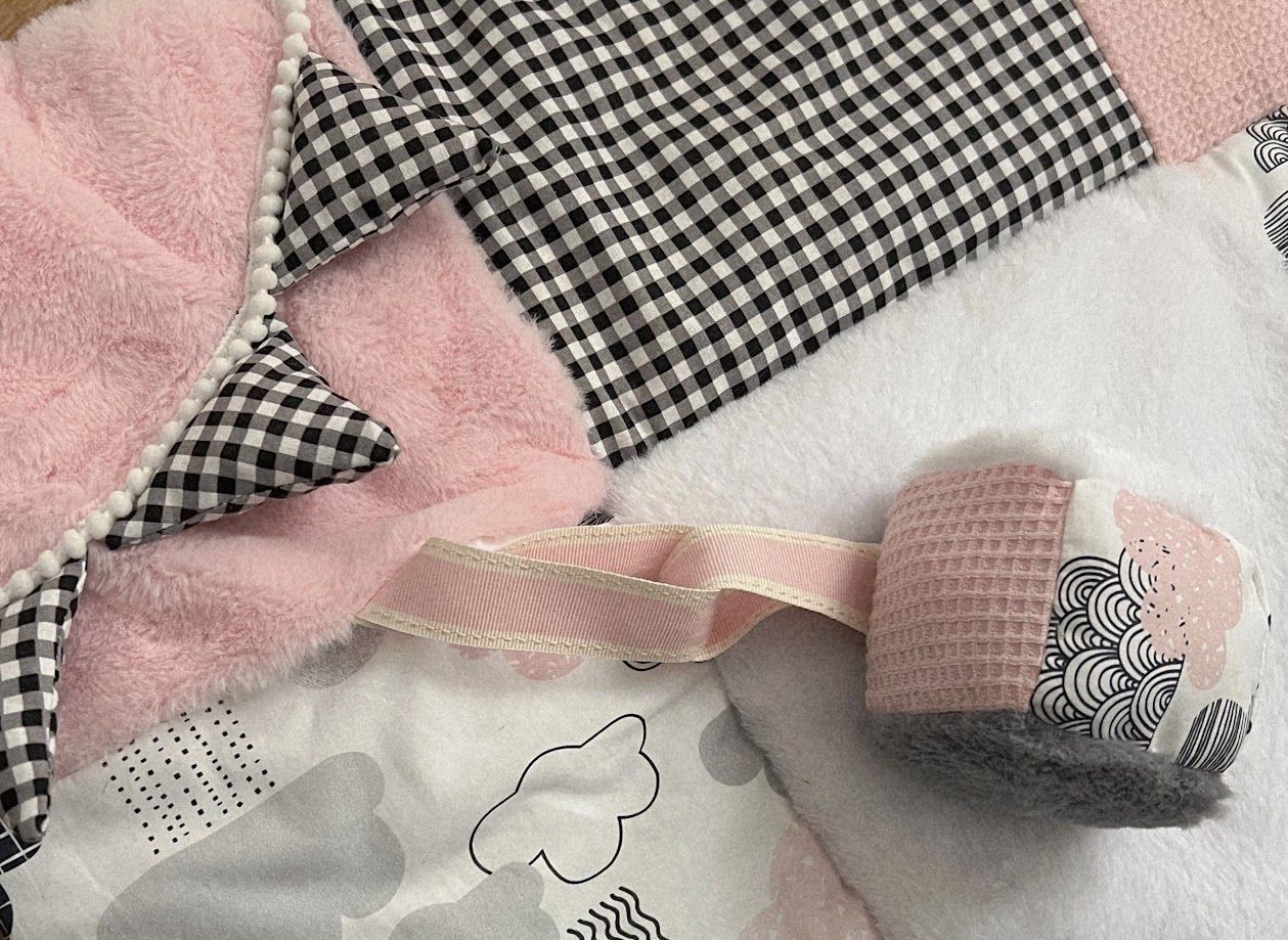 Pink and black gingham baby nursery set with waffle knit pacifier clip and cloud print blanket.