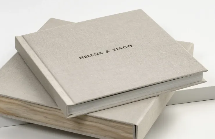 Minimalist gray linen-bound wedding photo albums displayed in a row showing various angles and perspectives.