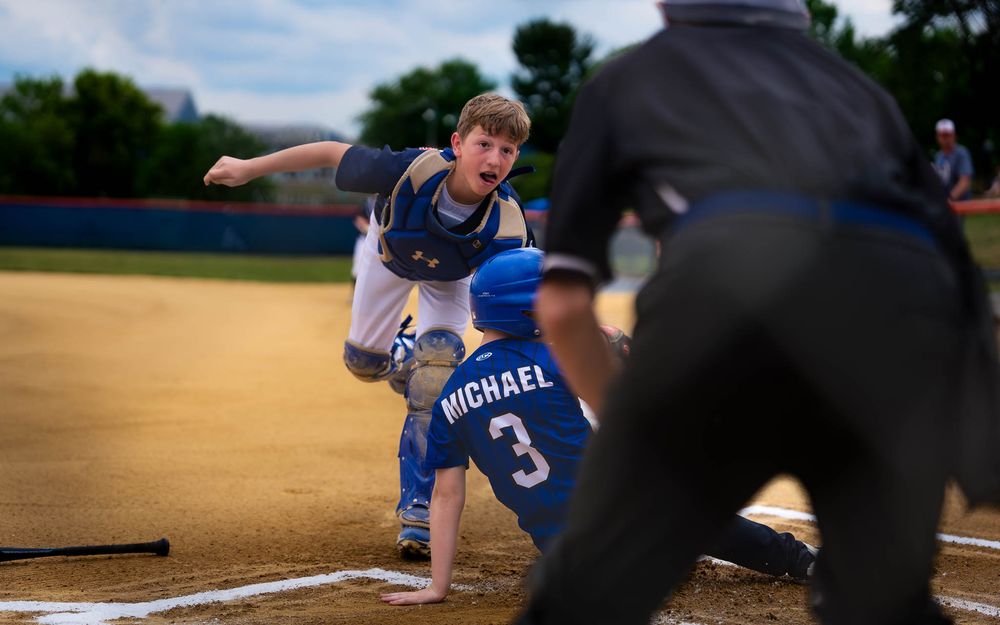 A baserunner scrambles as the umpire signals the call in Summer Slam baseball, by Deanna Fox, SportsFox Photography based in Hershey PA