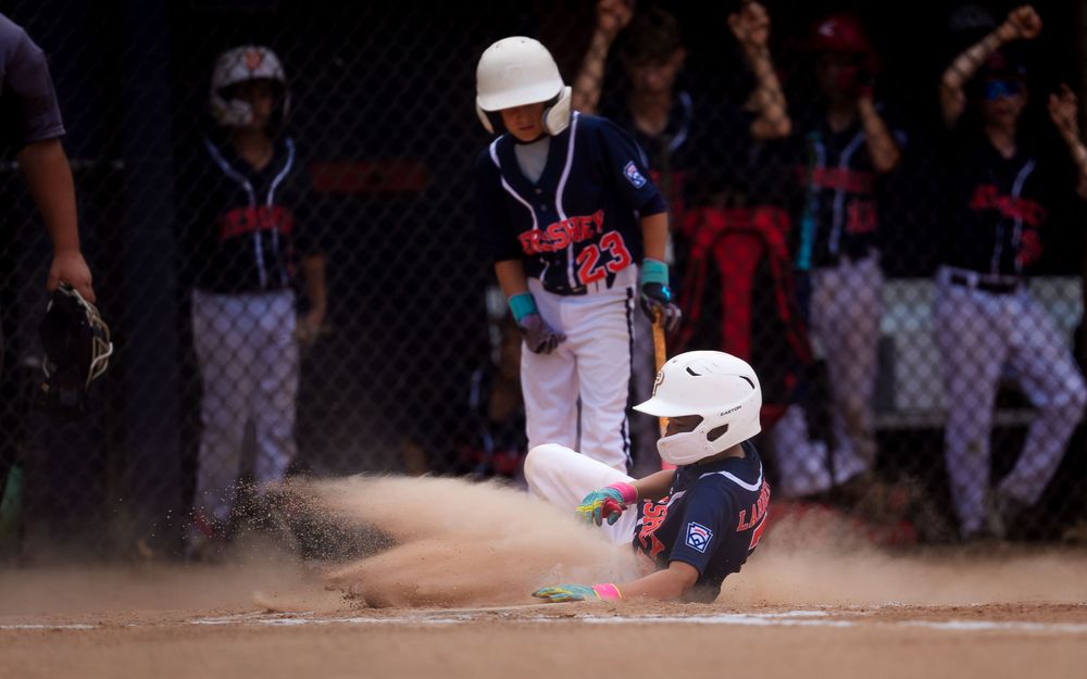 Hershey 12U baserunner slides in through a cloud of dust in Summer Slam baseball, by Deanna Fox, SportsFox Photography based in Hershey PA