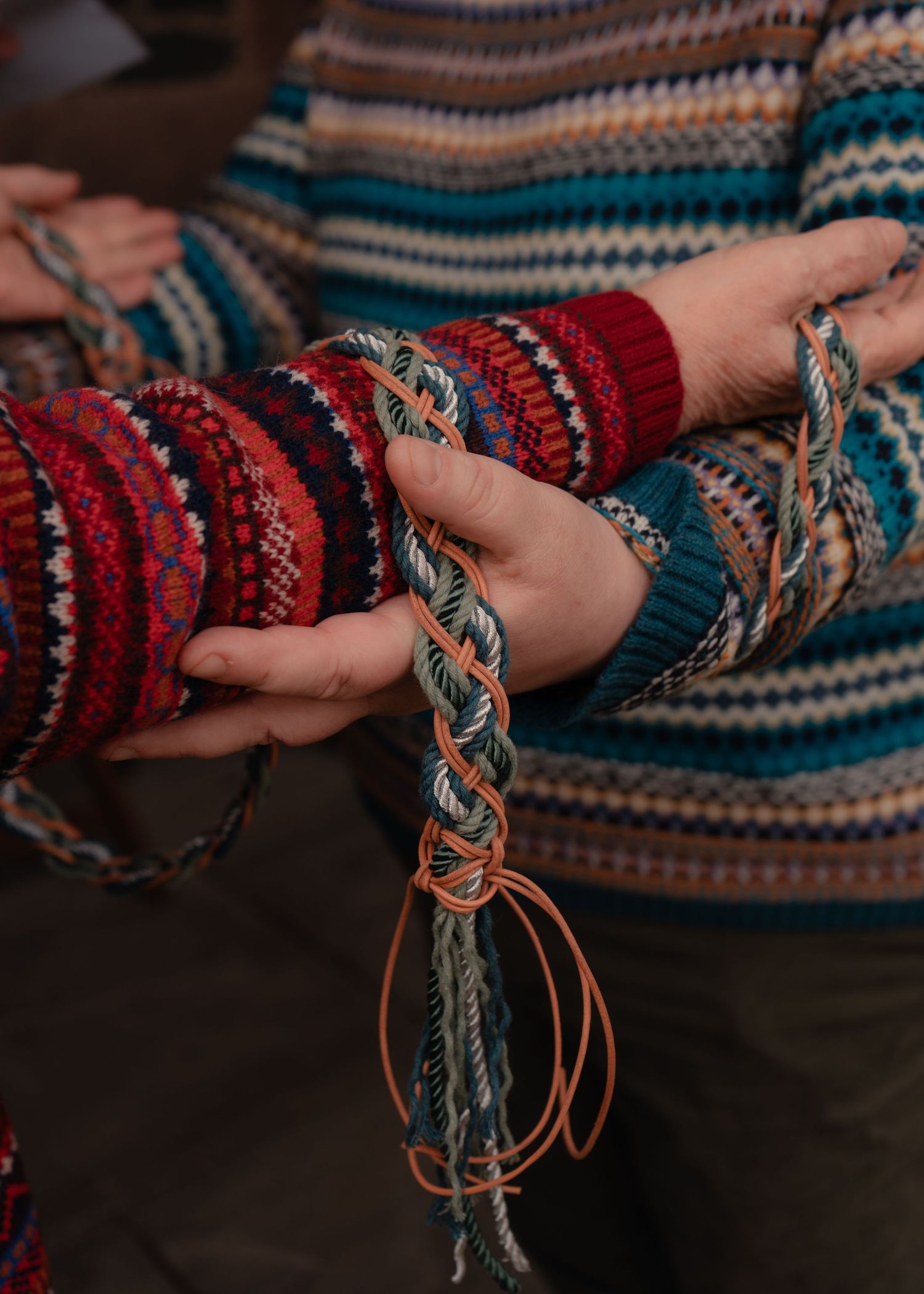 Detailed photograph of a handfasting ritual during a Scottish humanist wedding ceremony, celebrating an ancient Celtic tradition.