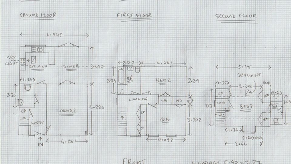 Hand-drawn architectural floor plans showing ground, first, and second floor layouts of a multi-story residential home on graph paper.