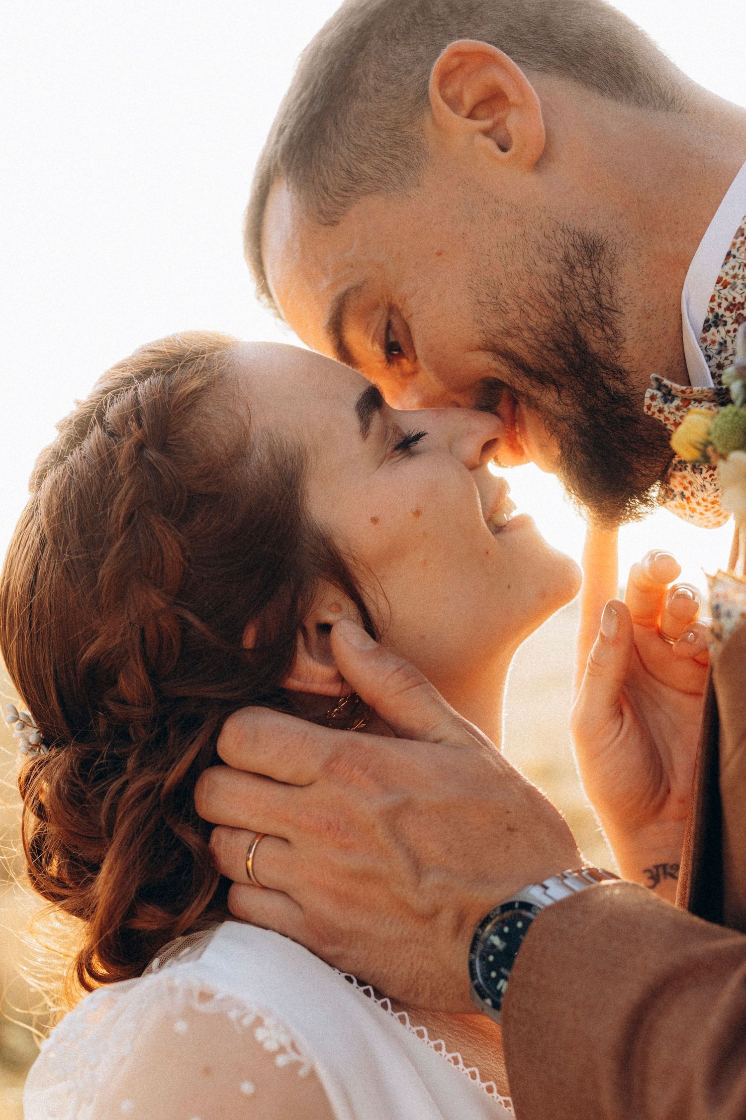 A tender autumn embrace captured during a wedding photoshoot with fall foliage.