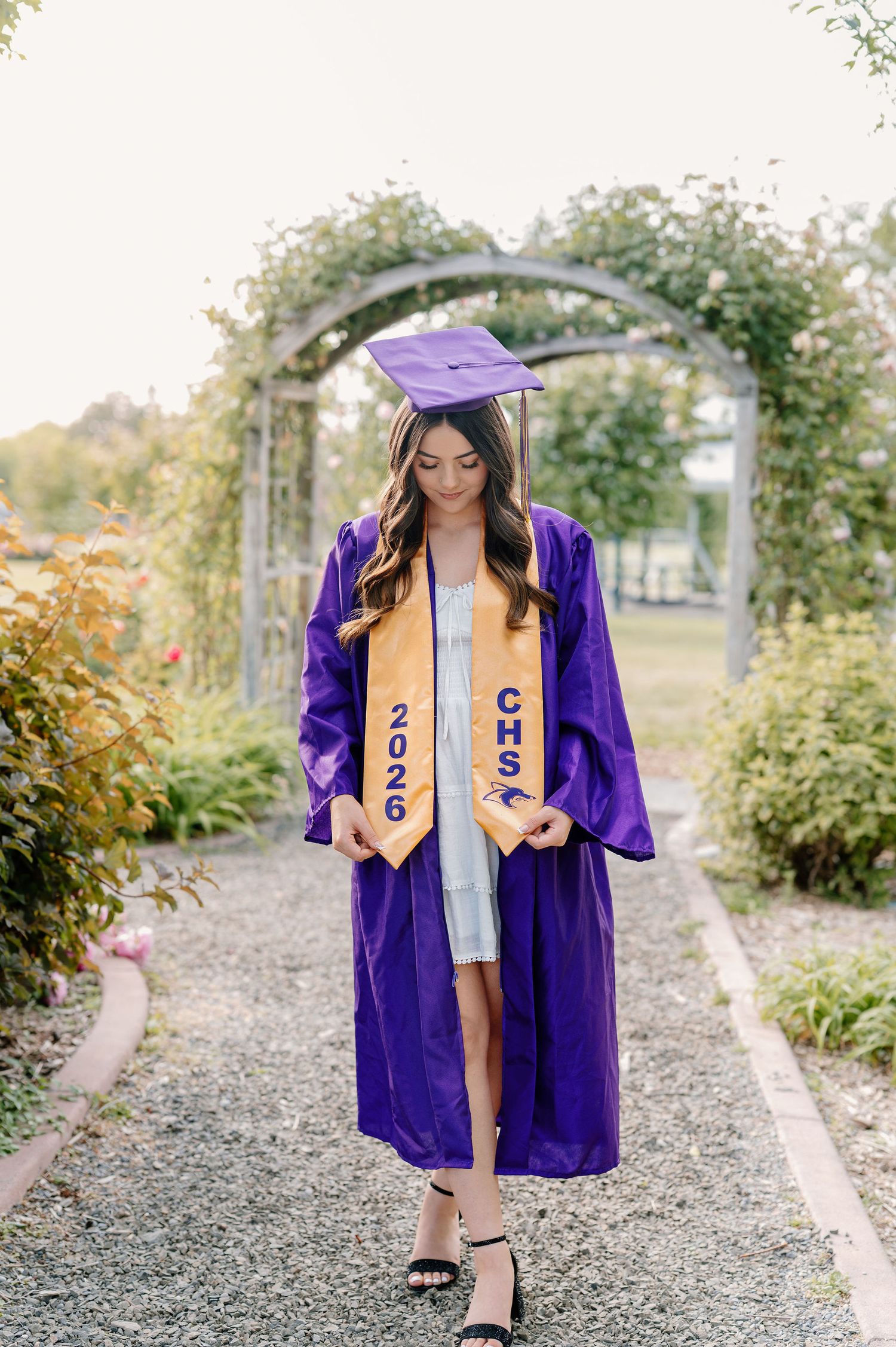 2026 senior with her cap and gown at WSU Demonstration Gardens in Tri-Cities, WA