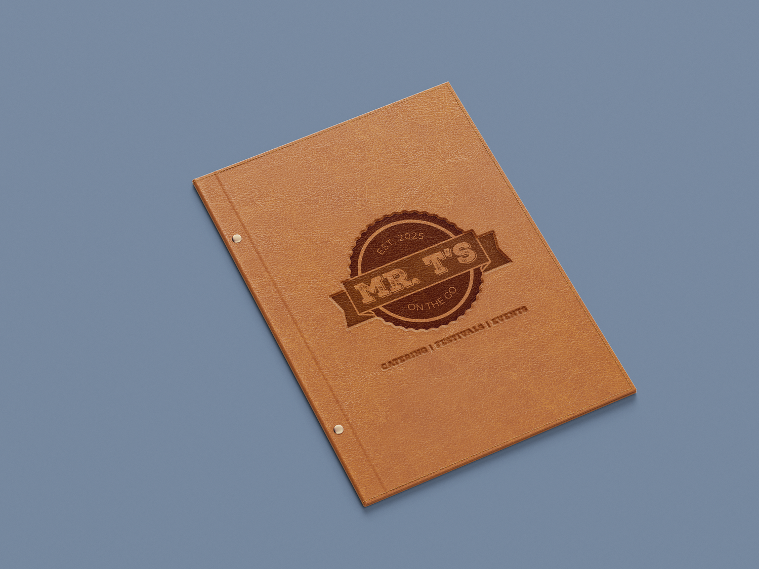 Mr. T's branded kraft paper folder with embossed vintage logo design on blue background.