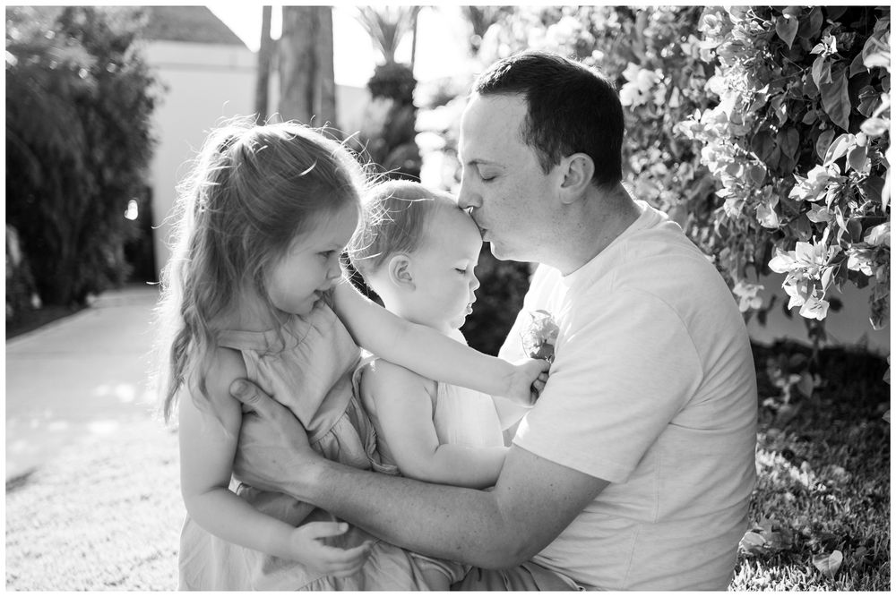 Grand Velas Riviera Nayarit Family Photographer capturing a father sharing a tender moment with his children during lifestyle family photos