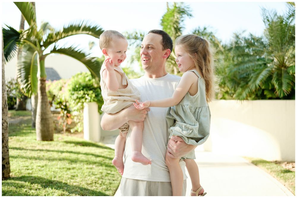 Grand Velas Riviera Nayarit Family Photographer capturing a father holding his two children during vacation family photos