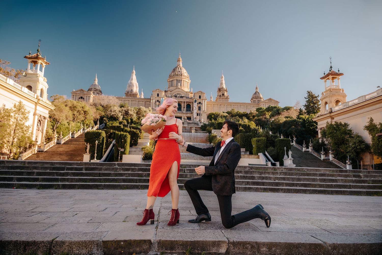 Tender hug between an engaged couple on the monumental staircases of Montjuic Barcelona.