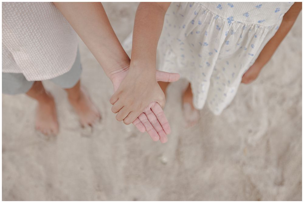 St Regis Punta Mita Family Photographer capturing siblings holding hands on the beach from above during Punta Mita Family Photos.