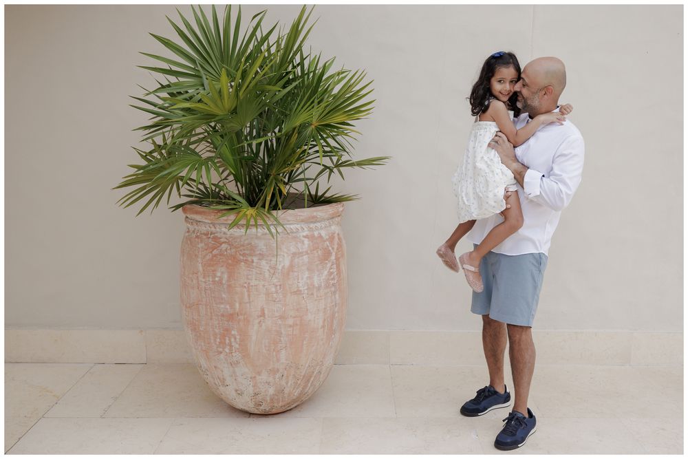 St Regis Punta Mita Family Photographer capturing a father and daughter portrait near a terracotta pot during Beach Family Photos