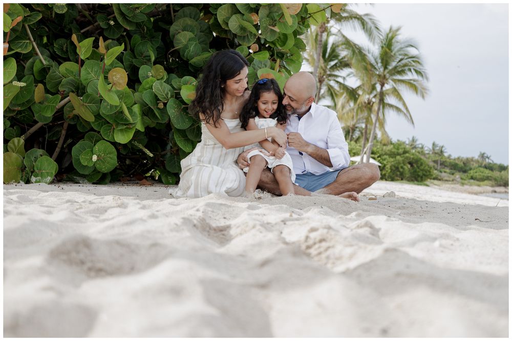 St Regis Punta Mita Family Photographer capturing a family portrait on white sand with tropical greenery during Beach Family Photo Session.