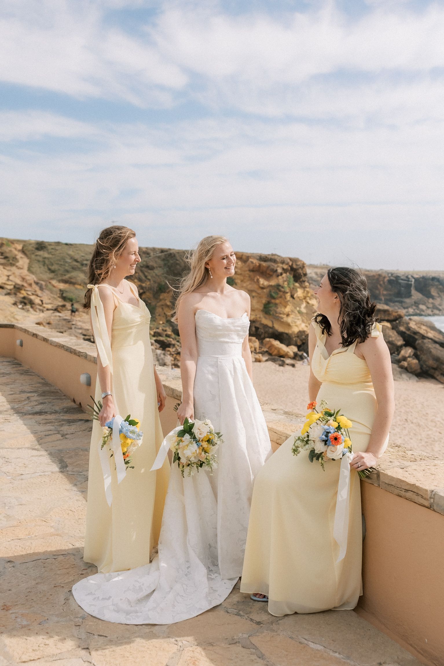 Bride and bridesmaids overlooking the Atlantic coastline after the ceremony at Arriba by the Sea.