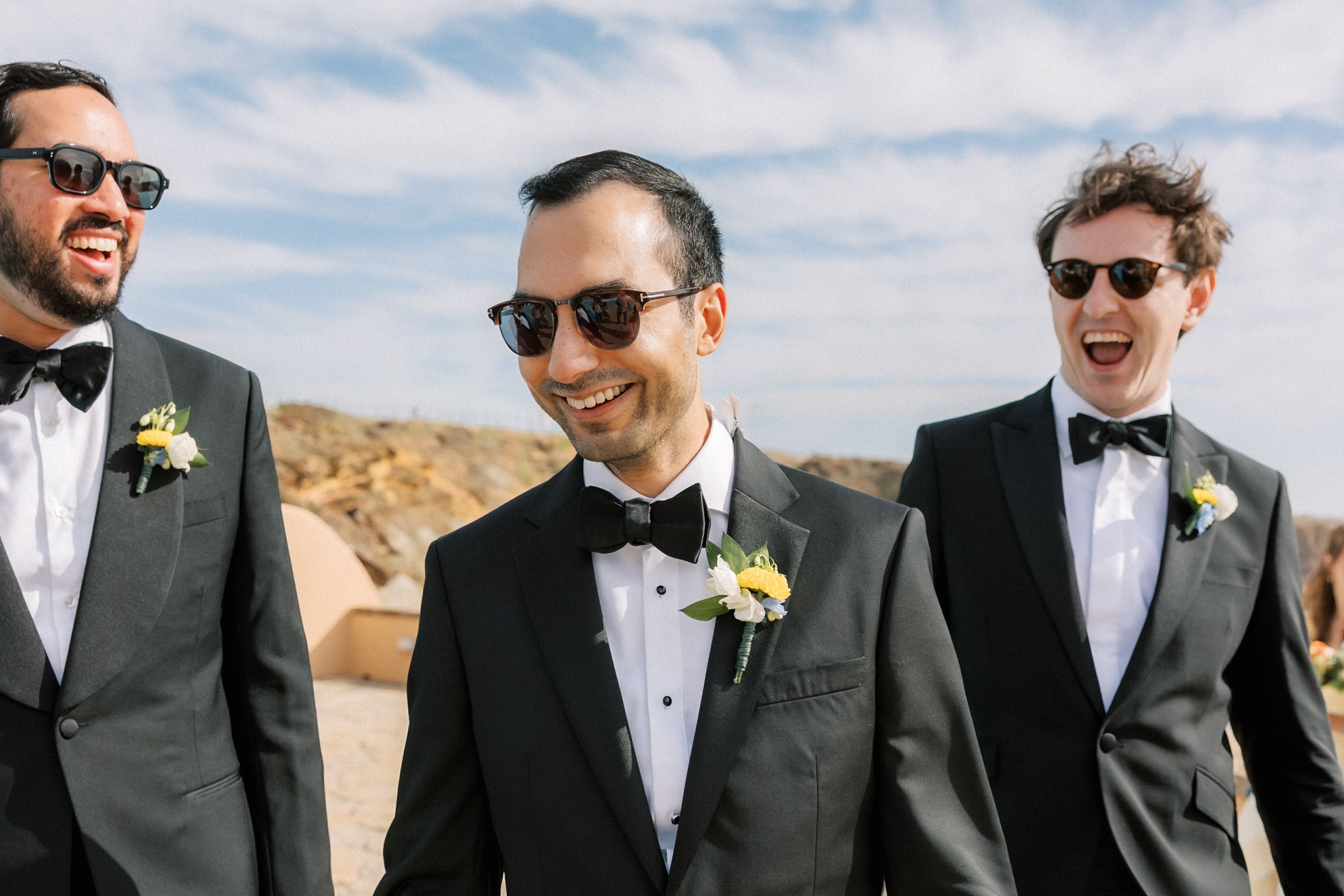 Groom and his best friends laughing together before a destination wedding in Cascais, photographed by a Portugal wedding photographer.