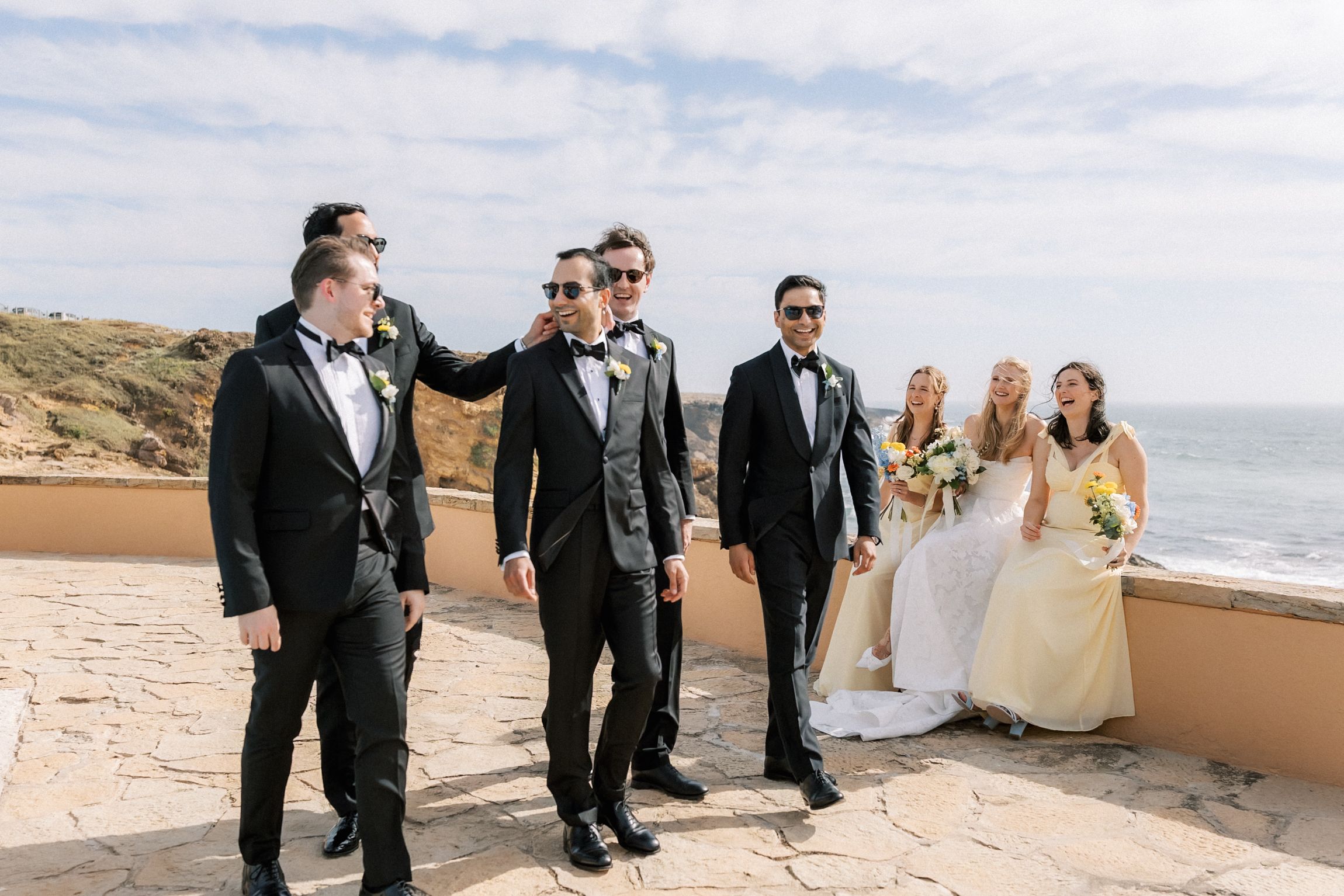 Modern groom portraits with his groomsmen before an oceanfront wedding at Arriba by the Sea in Portugal.