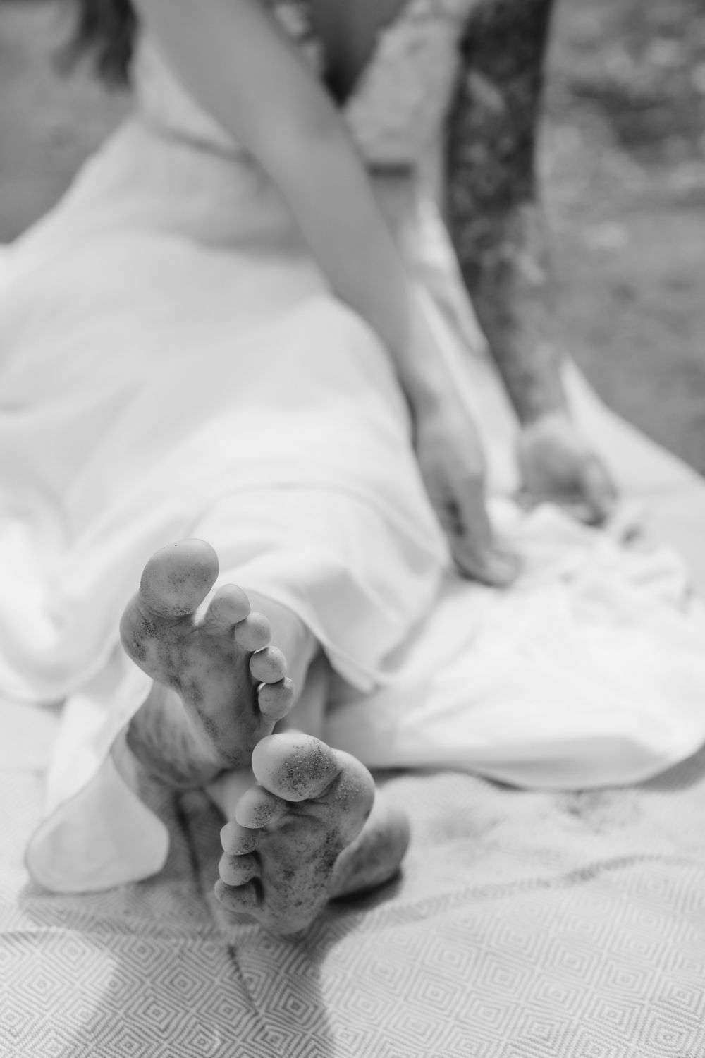 A bride's bare feet during her elopement day picnic