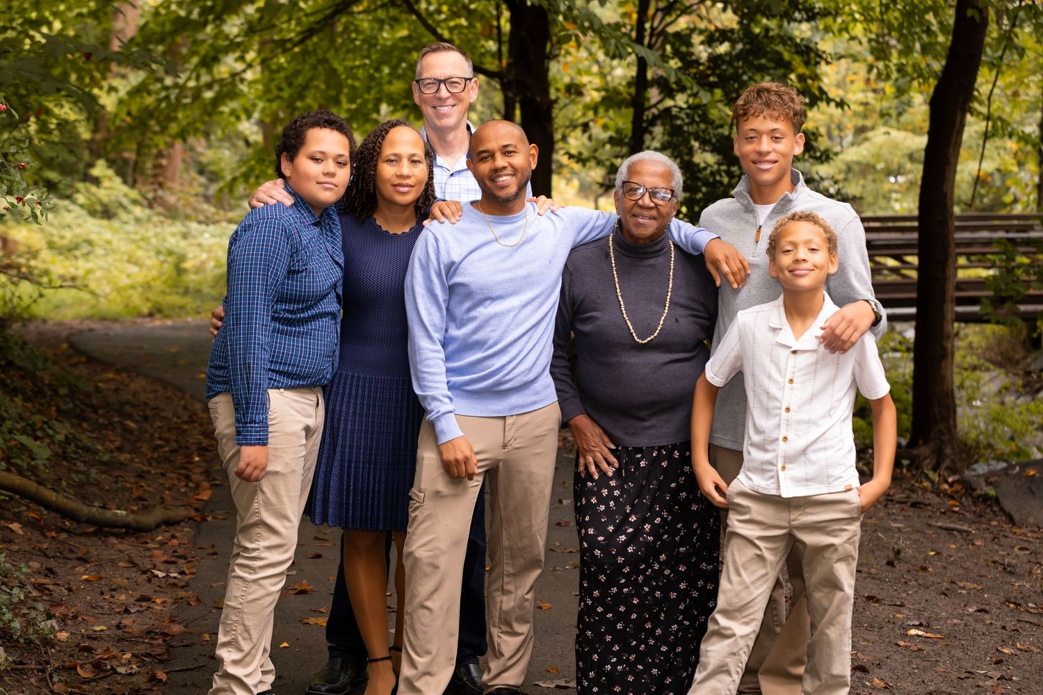 the group family portrait outdoors in a wooded area,