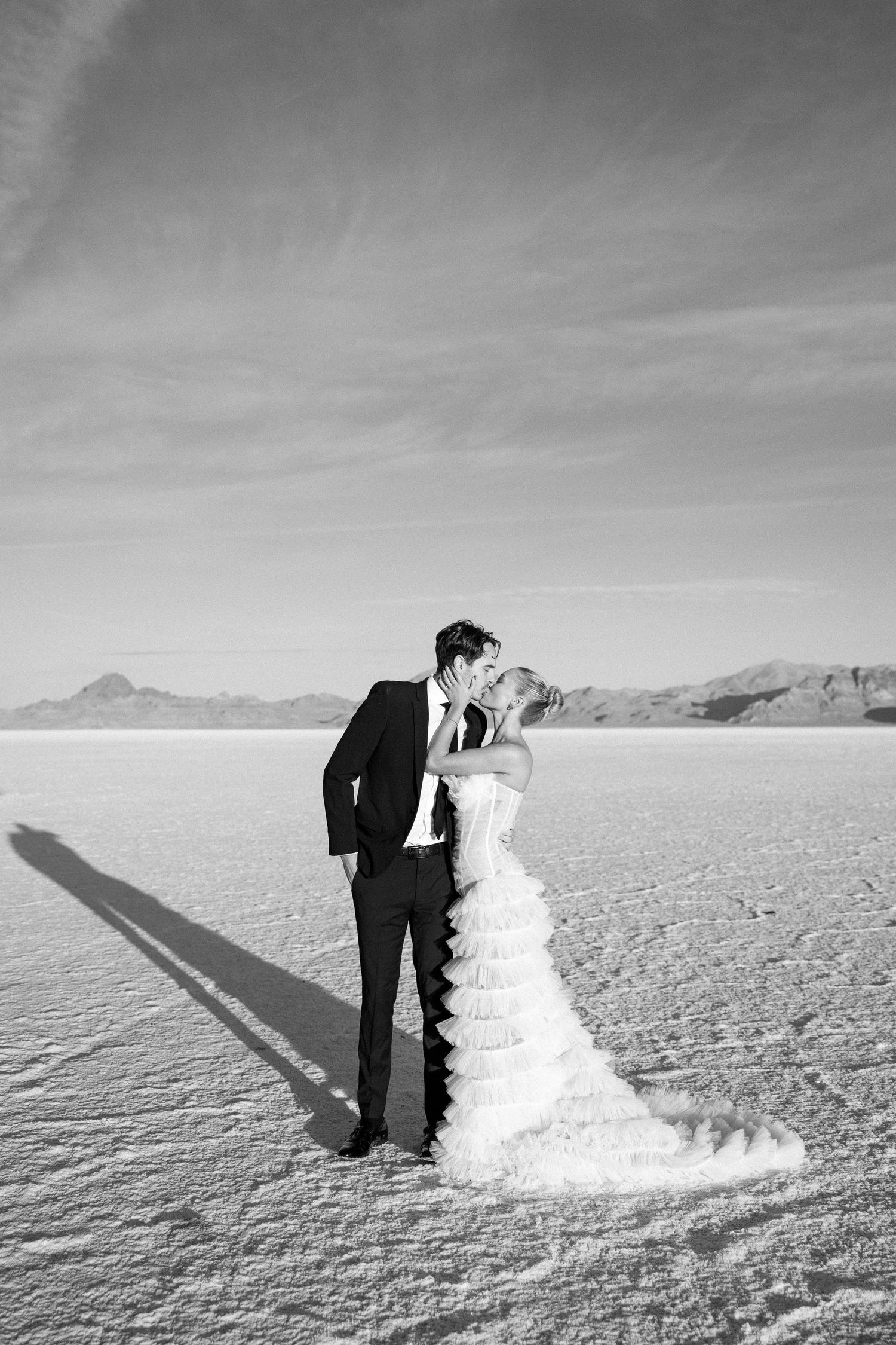 Couple sharing a romantic moment with yellow floral decorations in the background.