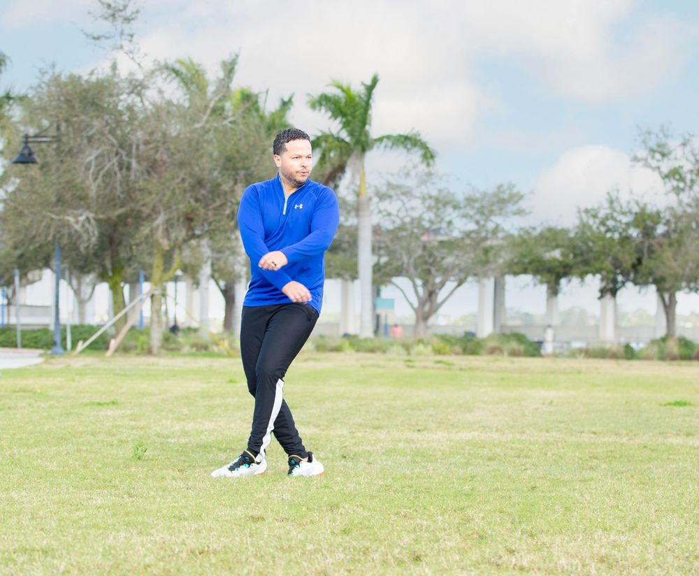 Man in a blue jacket outdoors by the water, on-location branding portrait in Bradenton