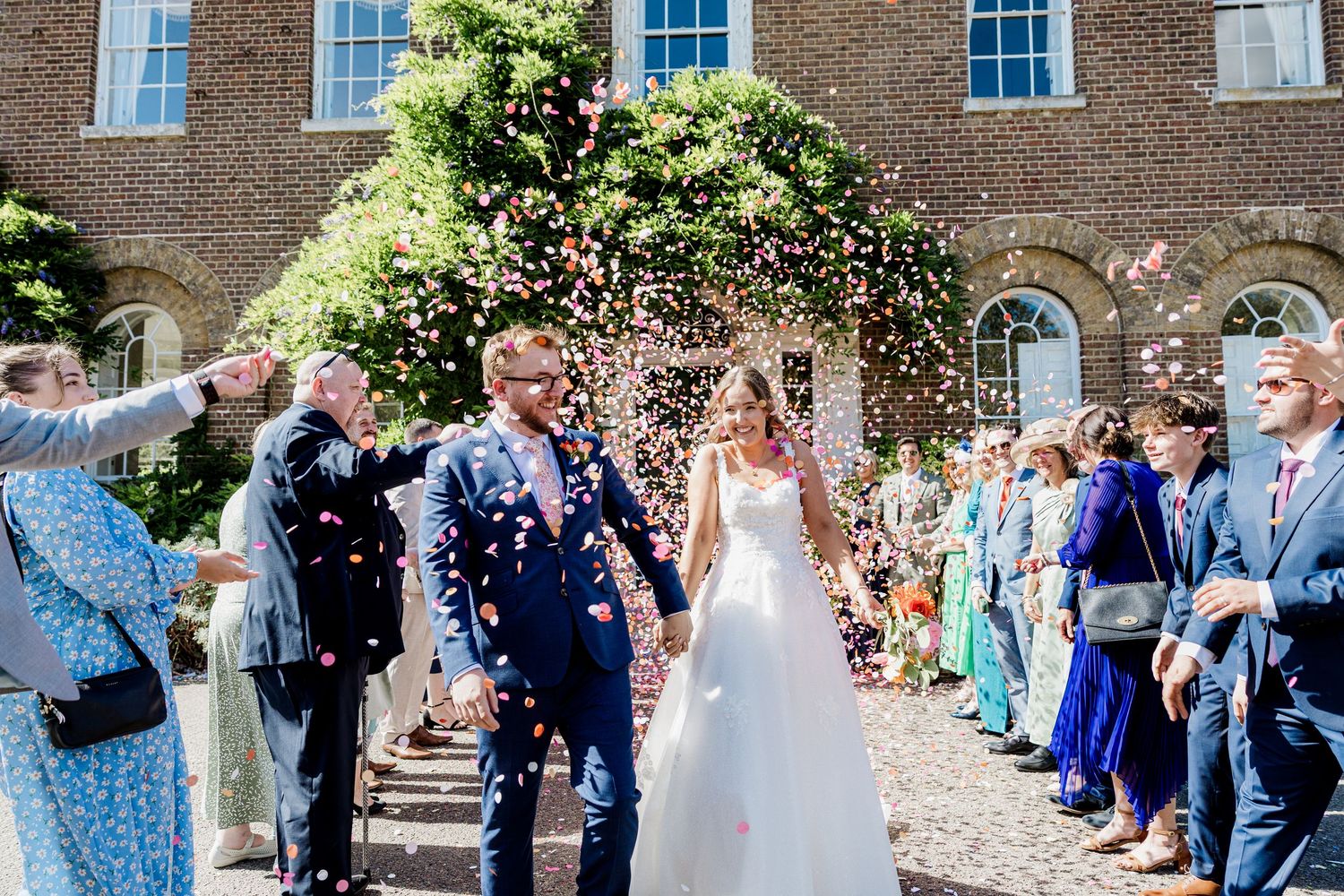 Wedding couple in confetti at Morden Park Barn