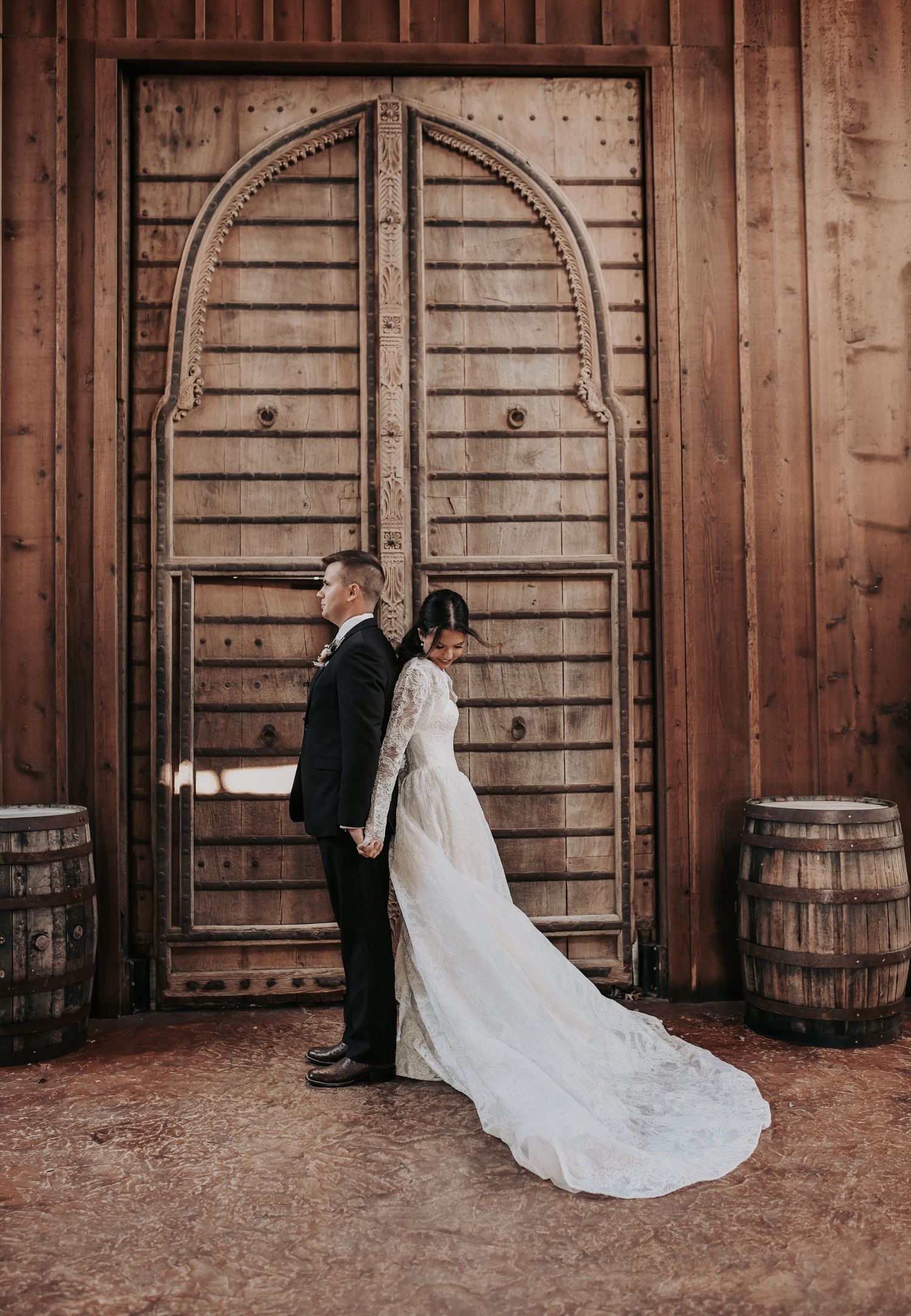 Bride and groom holding hands during first touch before Catholic wedding