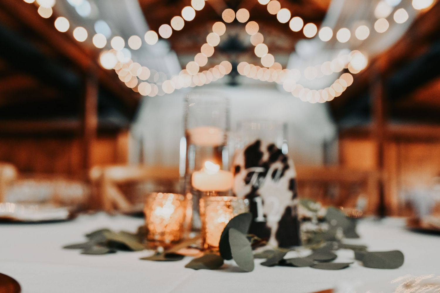 Elegant fall wedding table decor with gold accents and greenery