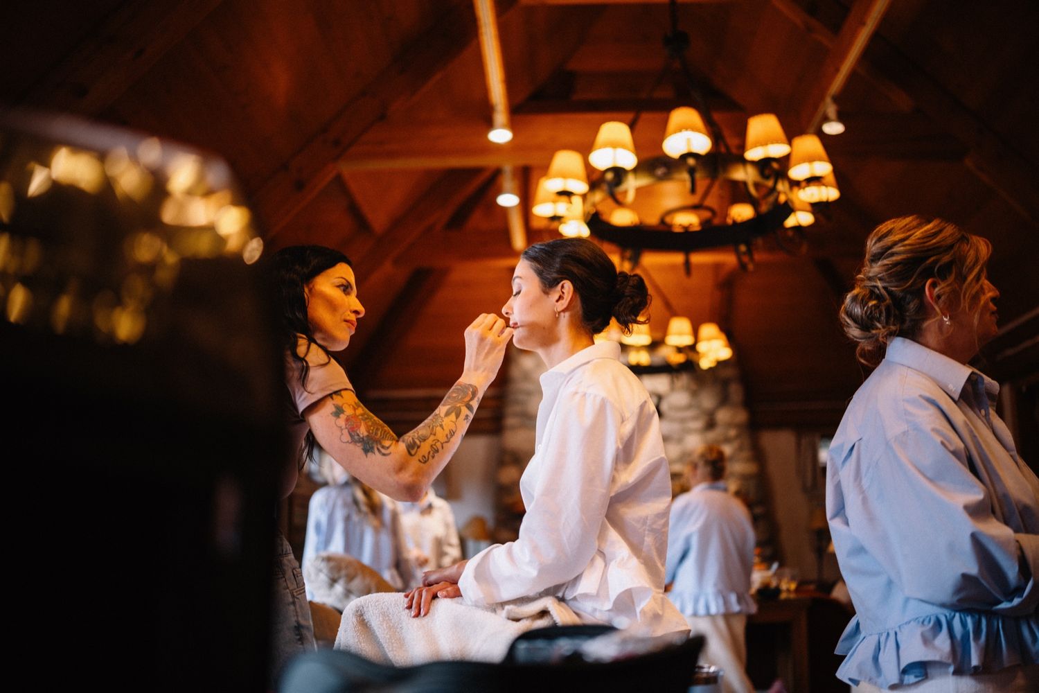 Bride getting ready under the chandeliers at The Post Hotel & Spa