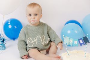 Adorable themed 1st birthday cake smash session in our Ridgefield, CT studio. Custom backdrops to celebrate your baby's big milestone!