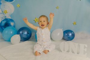 Adorable themed 1st birthday cake smash session in our Ridgefield, CT studio. Custom backdrops to celebrate your baby's big milestone!
