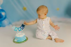 Adorable themed 1st birthday cake smash session in our Ridgefield, CT studio. Custom backdrops to celebrate your baby's big milestone!