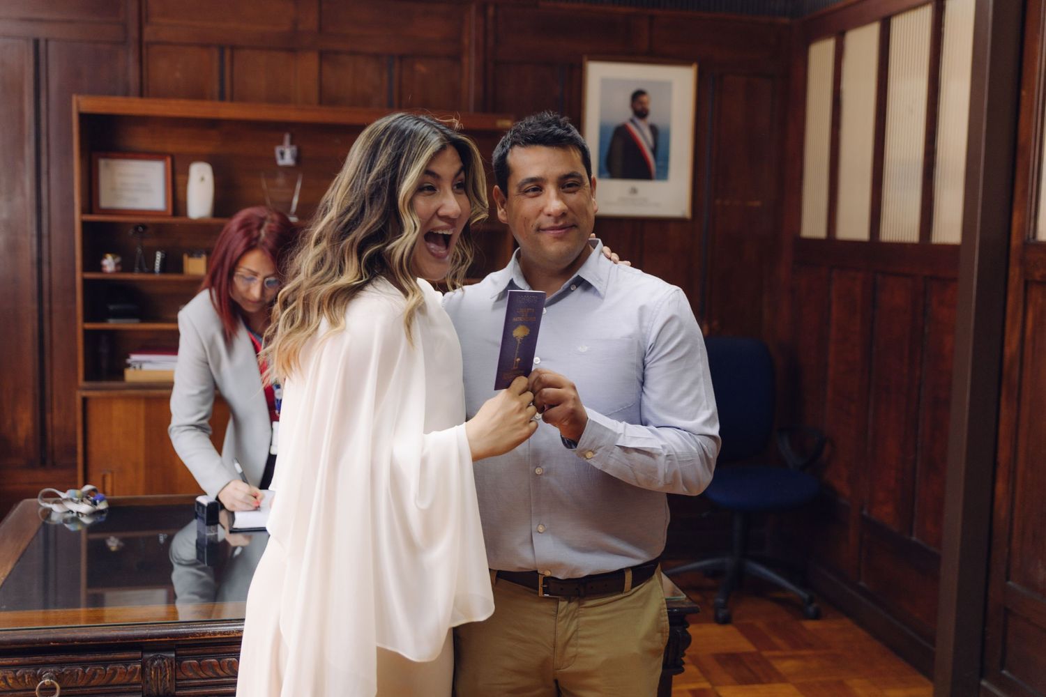 Bride playfully adjusting grooms tie while laughing together after their civil wedding ceremony.
