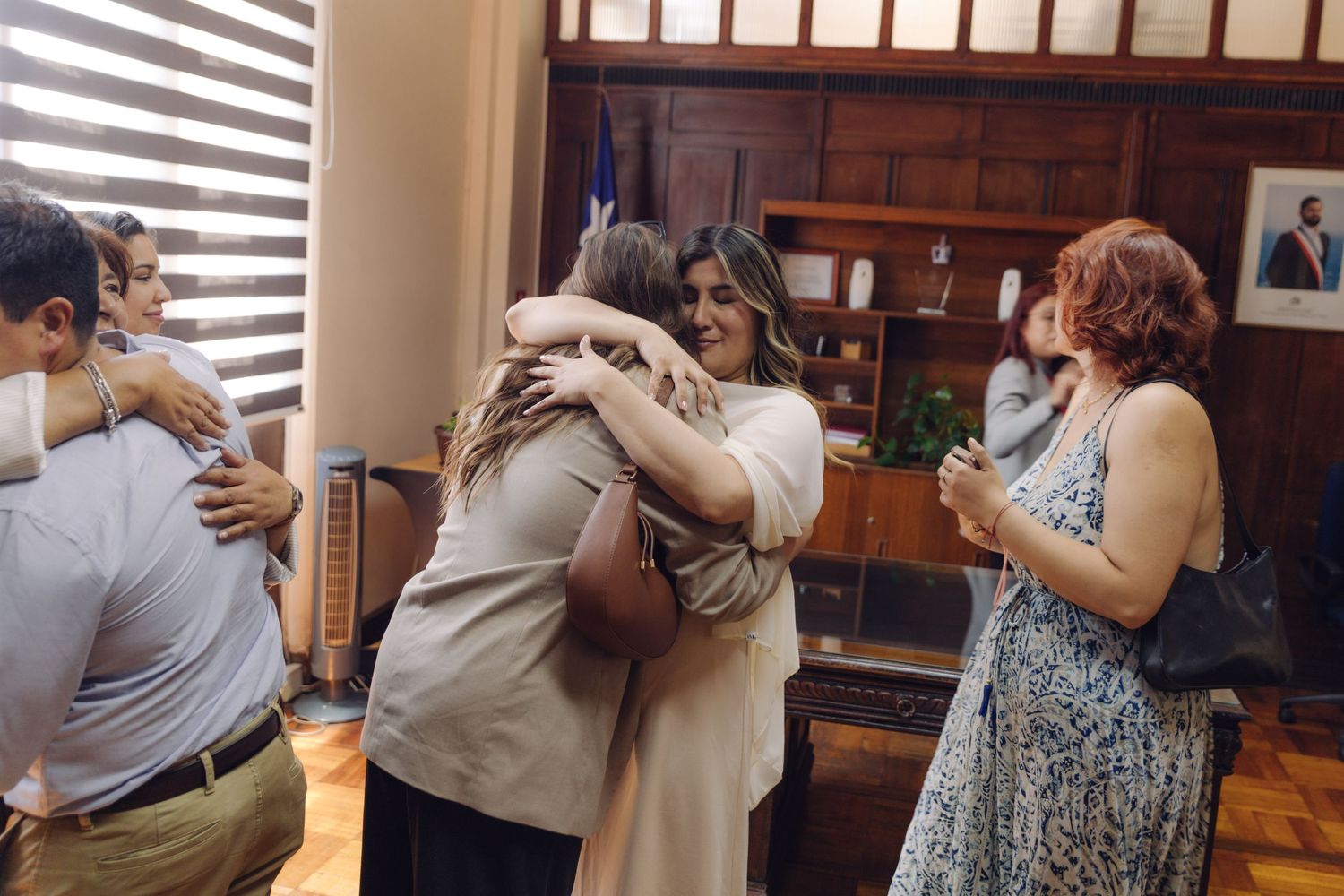 Newlywed bride hugging and celebrating with guests after completing their civil wedding ceremony.