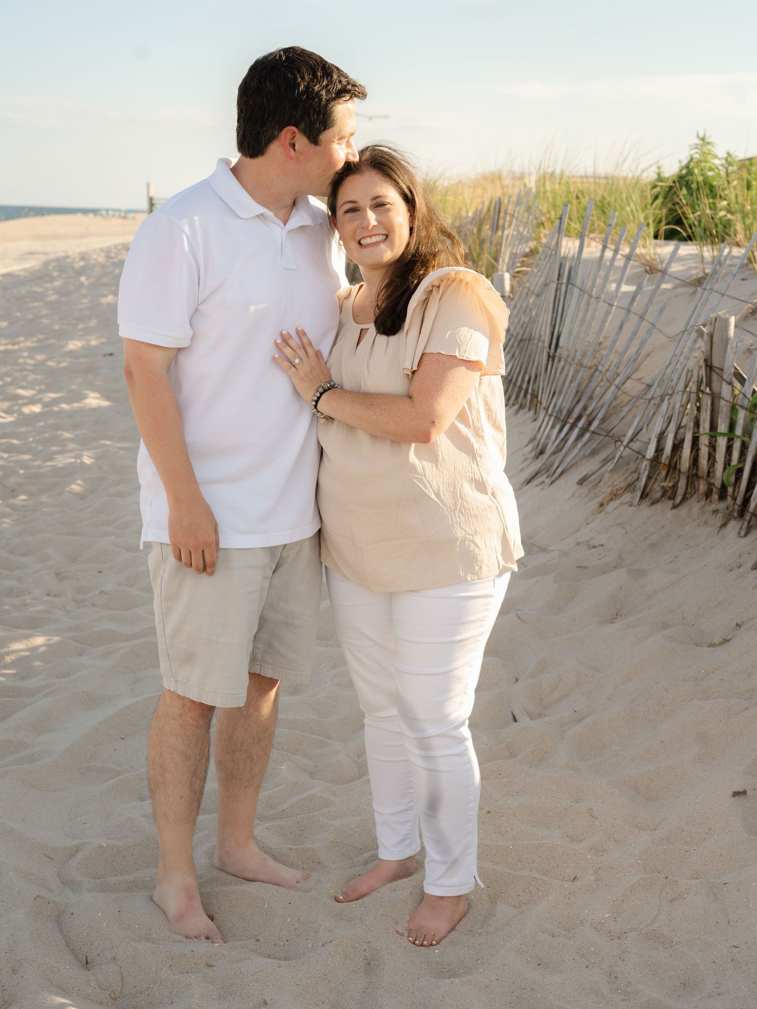 Young couple embrace each other near the dunes on New Jersey Ave in Point Pleasant.