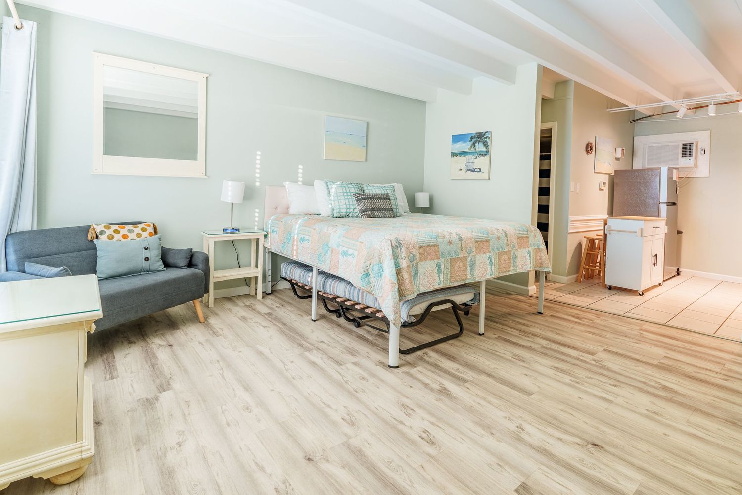 Bright interior of a Panama City Beach vacation rental condo featuring the bedroom and open living space