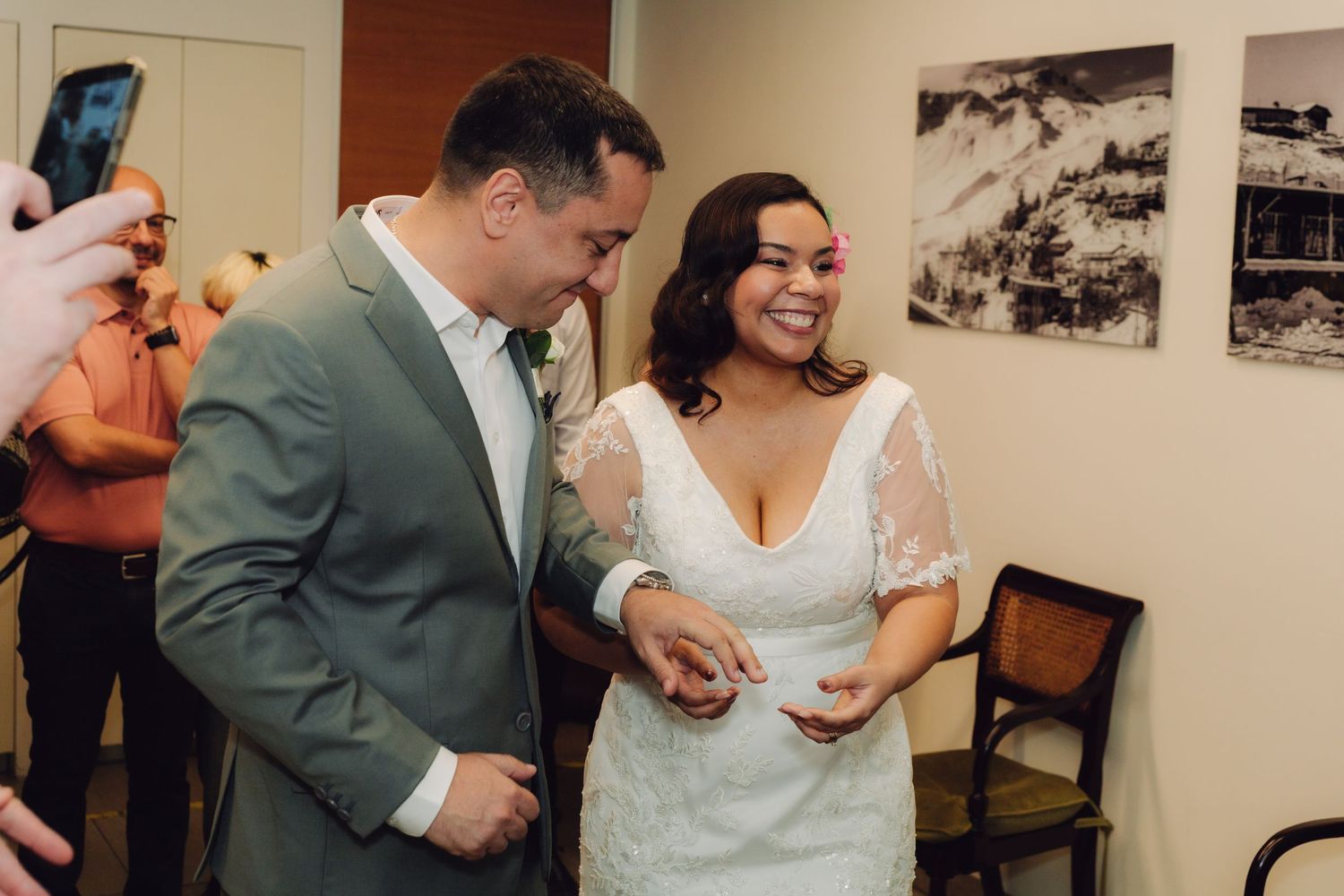 Newlyweds smile and hold hands joyfully after exchanging vows at civil wedding ceremony.