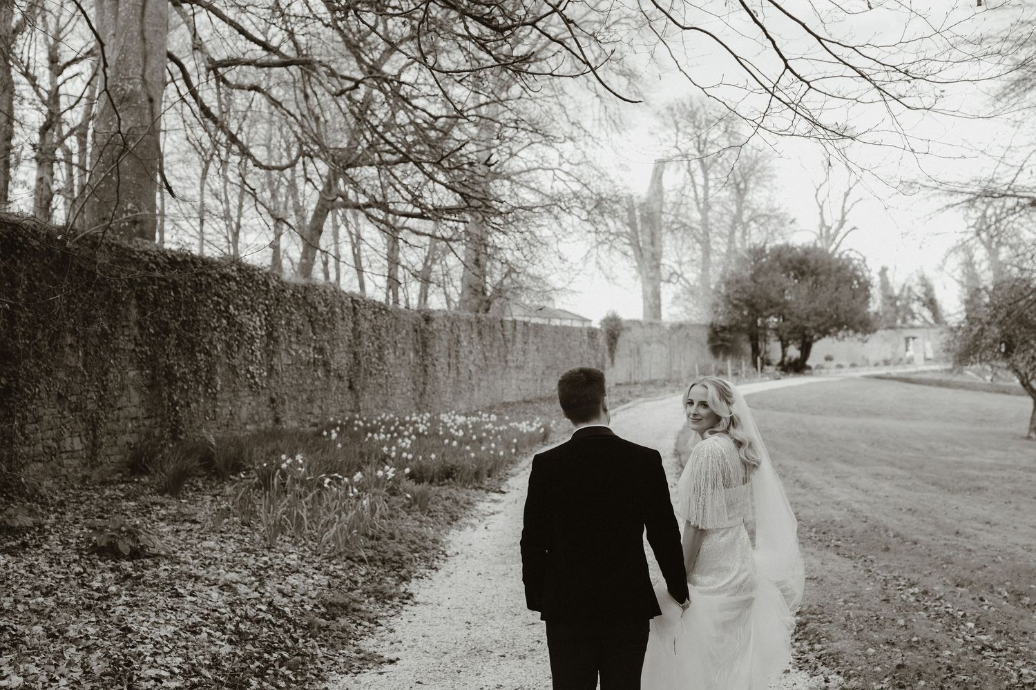 Bride and groom walking through the gardens at Boyne Hill House Estate, County Meath