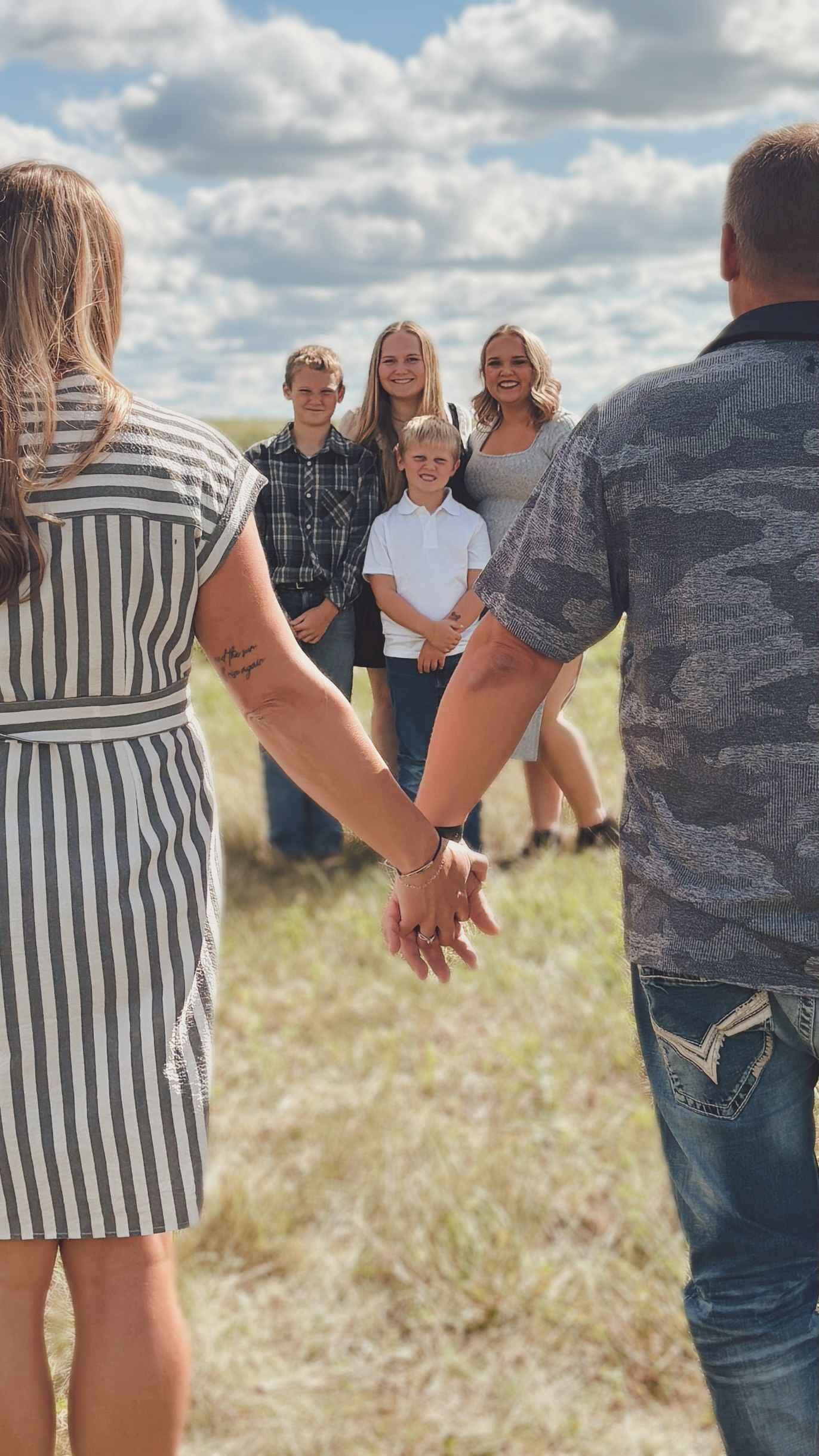 Family holding hands during an outdoor photography session in Eldorado, Wisconsin