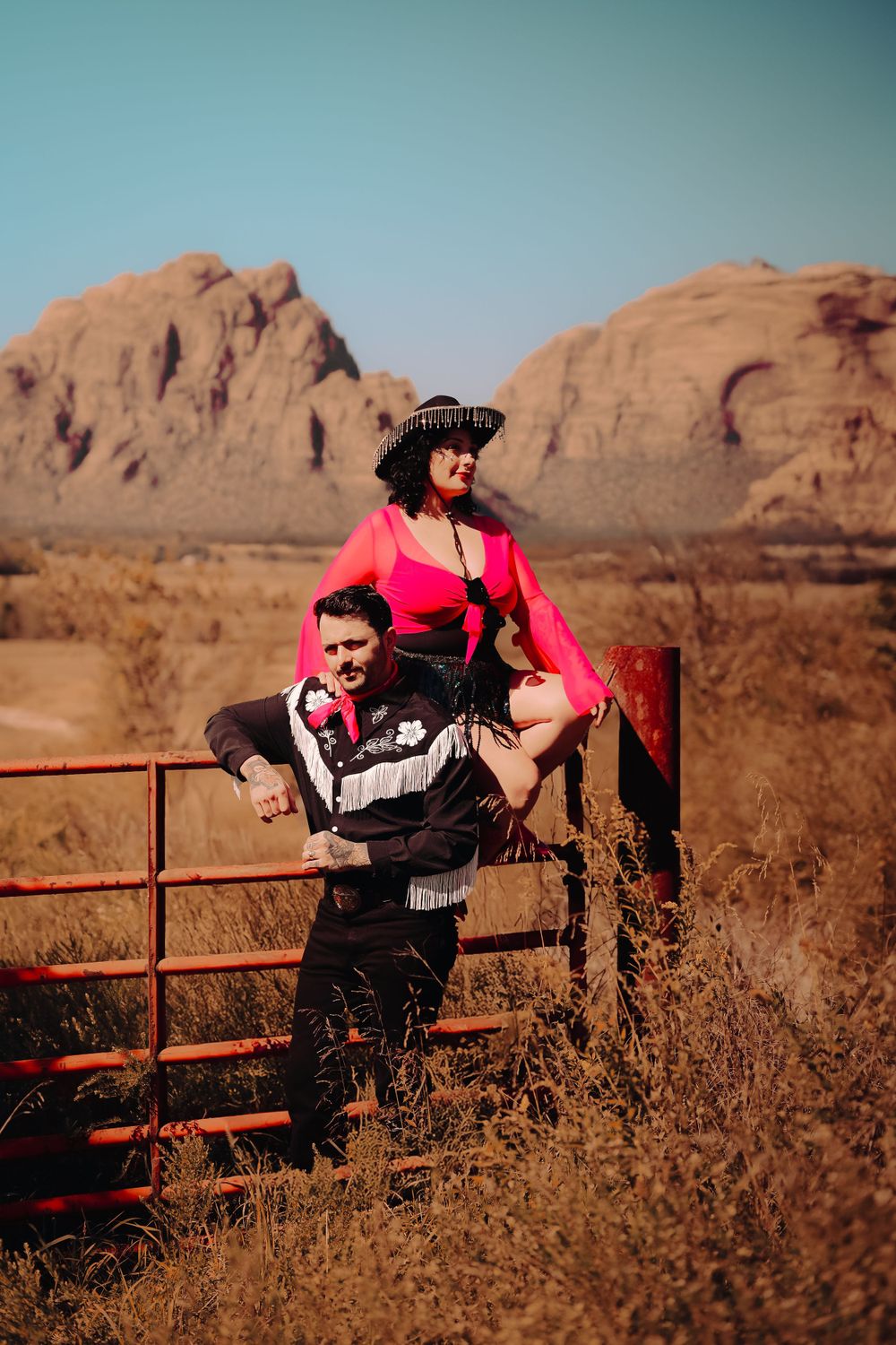 A romantic outdoor portrait in front of red rock formations in the desert landscape.
