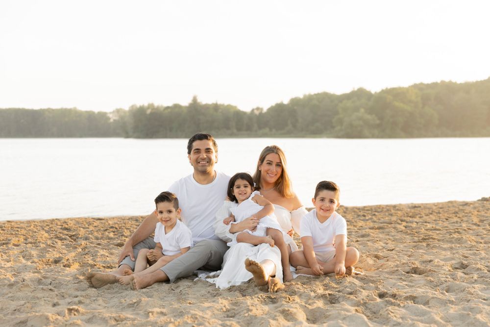 family sitting on the beach at Stoney Creek at sunset