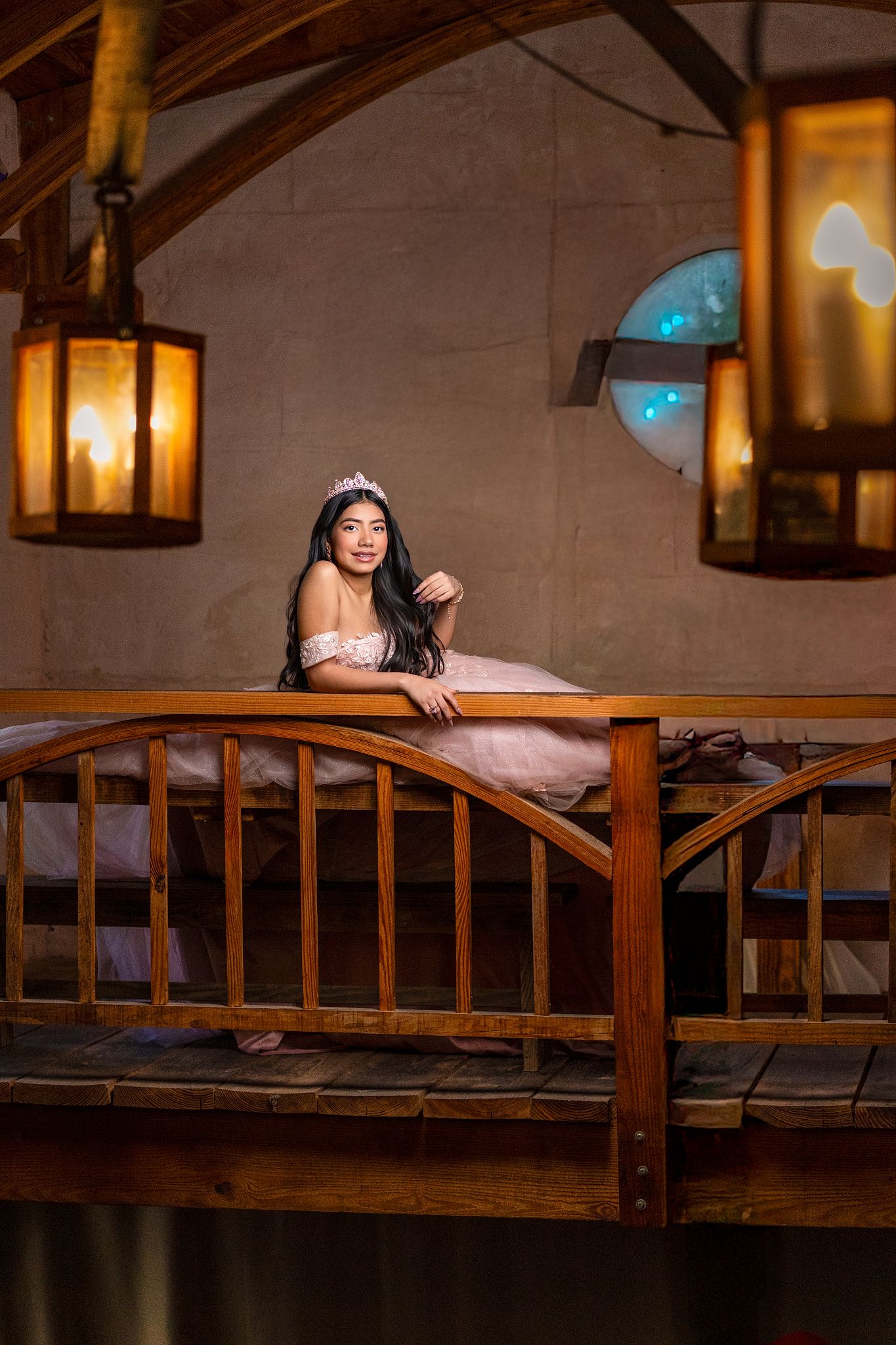 A wooden bridge or balcony railing with warm lighting and lanterns creating an intimate rustic ambiance.
