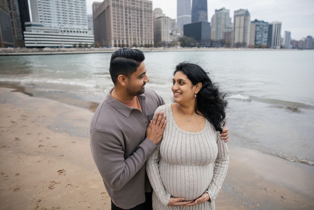 Intimate moment shared on Chicago's lakefront beach with urban skyline in background.