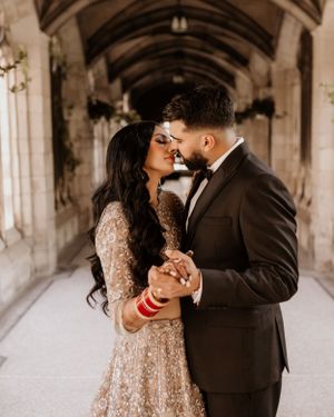 Intimate moment captured in ornate stone hallway during wedding photoshoot.