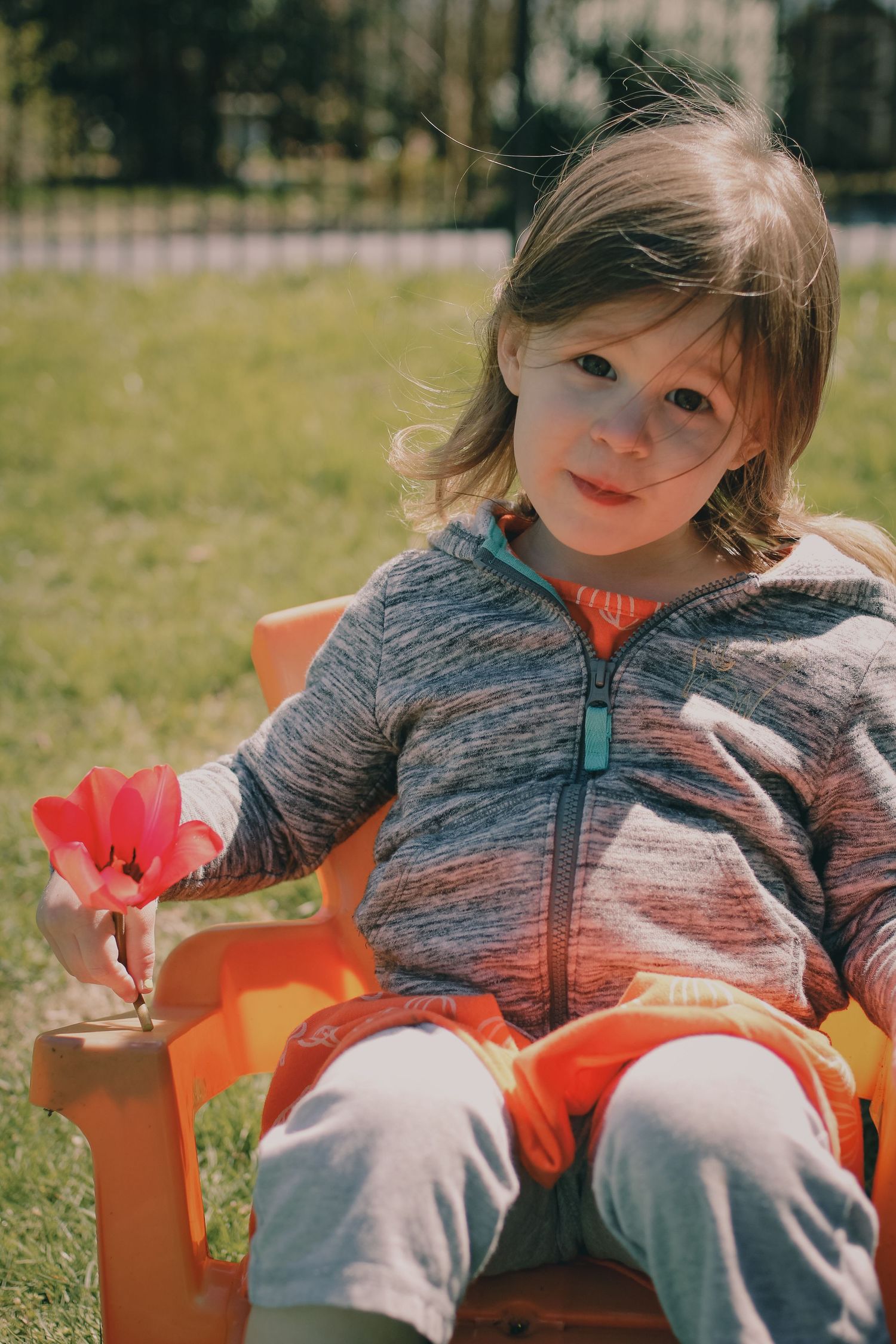 sitting girl holding a flower