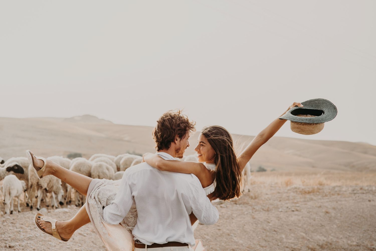 Playful desert photoshoot with joyful poses against arid landscape.