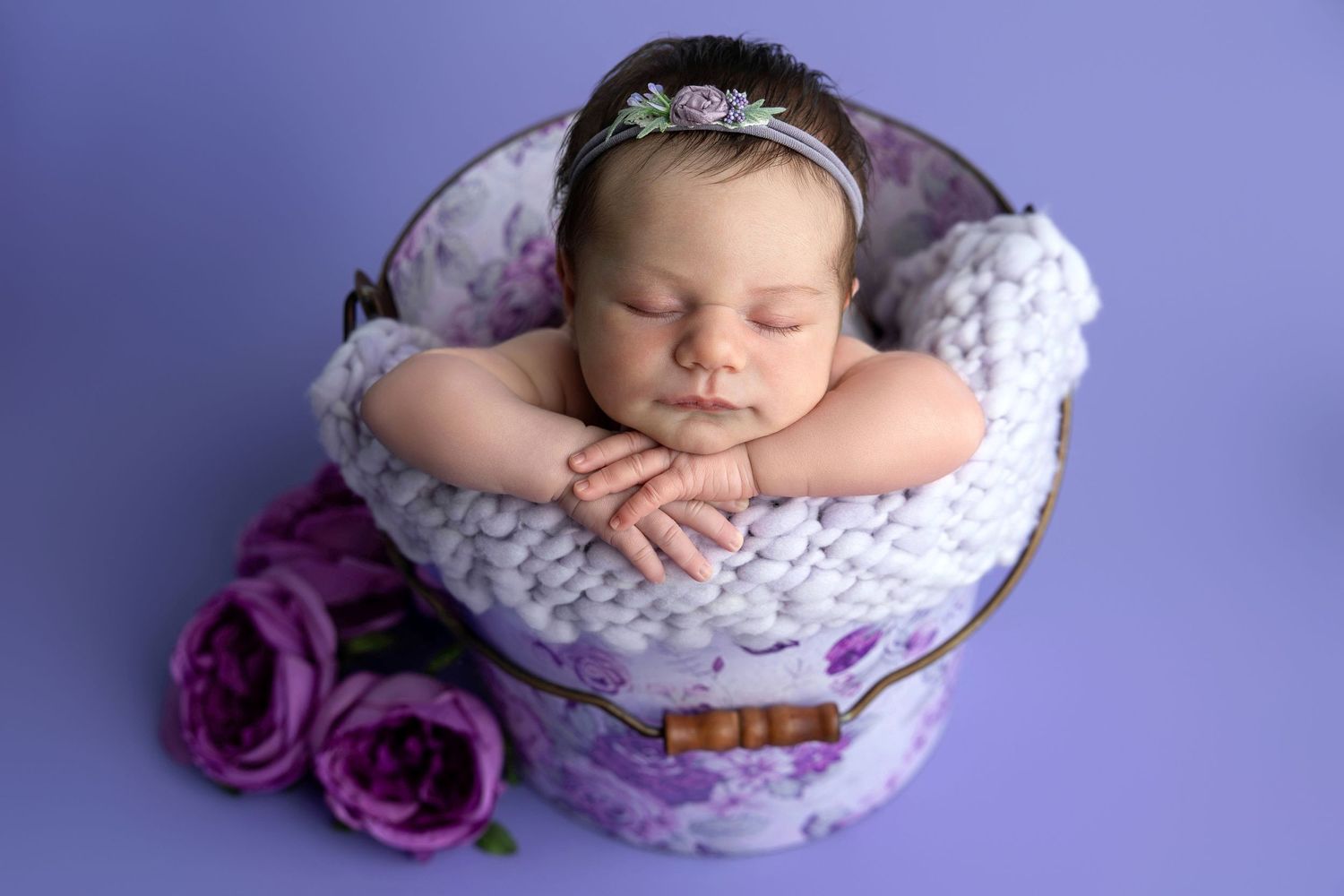 Newborn photography with yellow backdrop and colorful spring tulips.