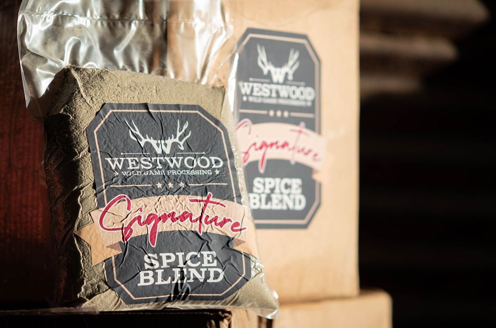 Close-up view of Westwood Signature Spice Blend packages with black and silver labels on dark background.