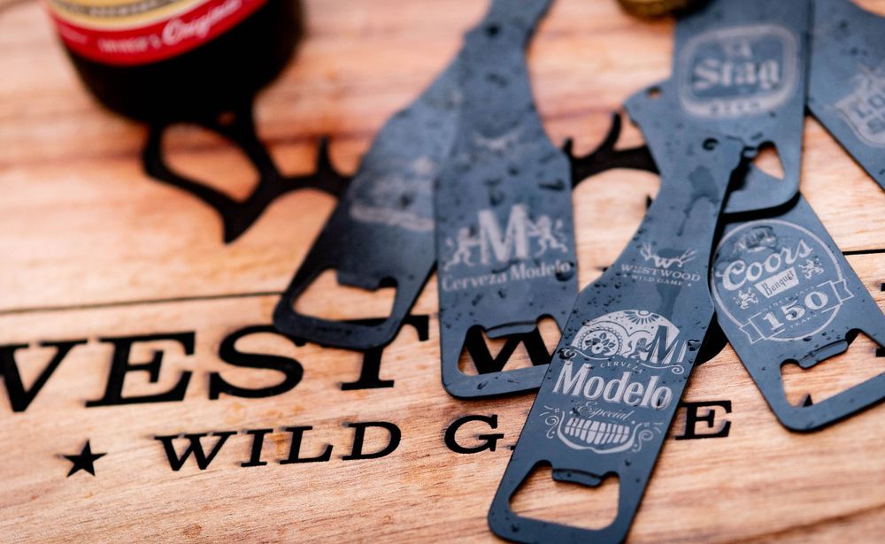 Close-up photo of a collection of rustic Western-style metal signs with weathered textures and typography.